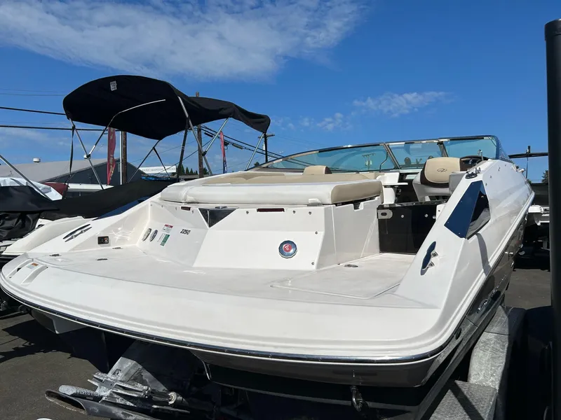 Slide: The Image of 2016 Regal 2250 Cuddy boat with sleek design, parked outdoors under blue sky. - 9