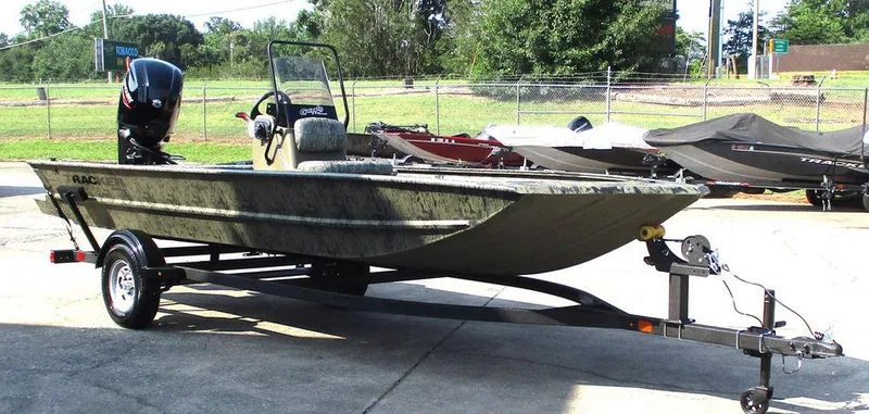 Slide: The Image of 2026 Tracker GRIZZLY® 1860 CC boat on trailer, parked outdoors. - 4