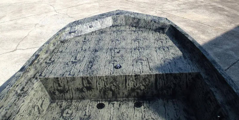 Slide: The Image of 2026 Tracker GRIZZLY® 1860 CC boat with camouflage interior design on concrete surface. - 6