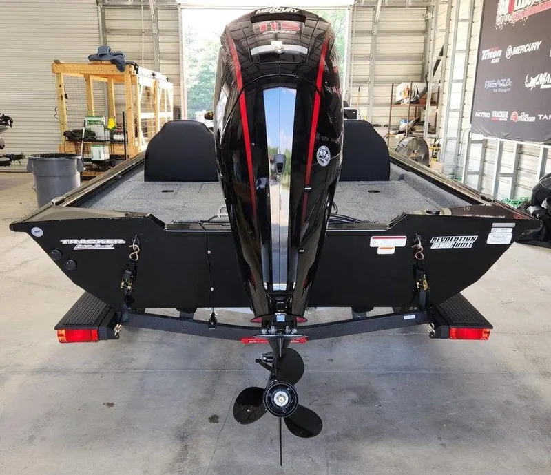 Slide: The Image of 2026 Tracker Pro Team™ 190 boat with Mercury 115 outboard motor in a garage. - 3