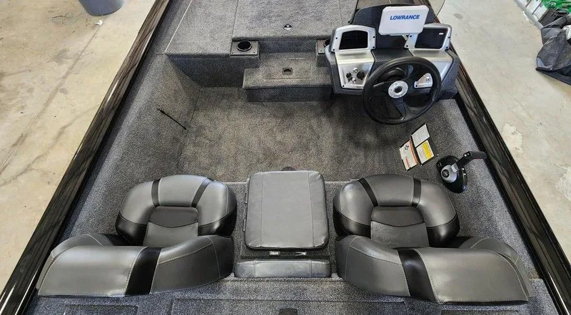 Slide: The Image of 2026 Tracker Pro Team™ 190 boat interior with steering console and seating. - 7