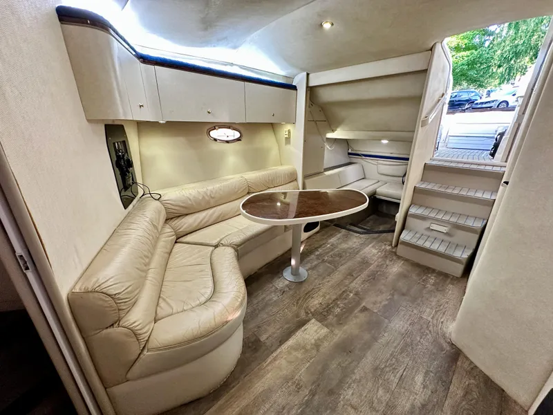Slide: The Image of Interior of 1997 Regal Commodore 402 yacht with beige seating and wooden flooring. - 13