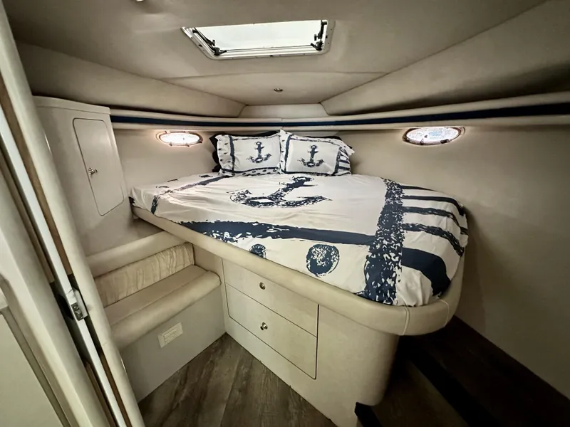 Slide: The Image of Cozy cabin interior of 1997 Regal Commodore 402 yacht with nautical-themed bedding. - 14