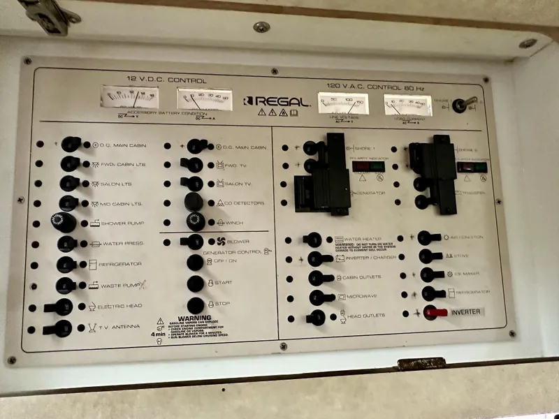 Slide: The Image of Control panel of a 1997 Regal Commodore 402 boat, featuring various switches and gauges. - 15