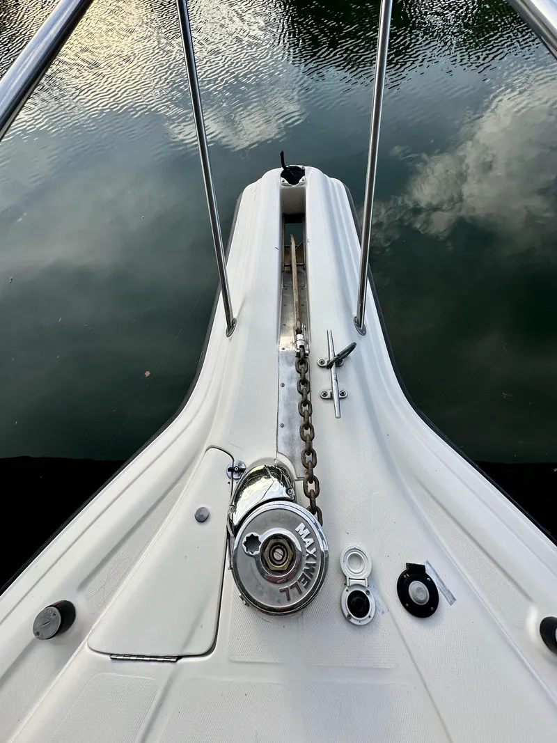 Slide: The Image of Bow of 1997 Regal Commodore 402 with anchor chain and winch, reflecting on water. - 16