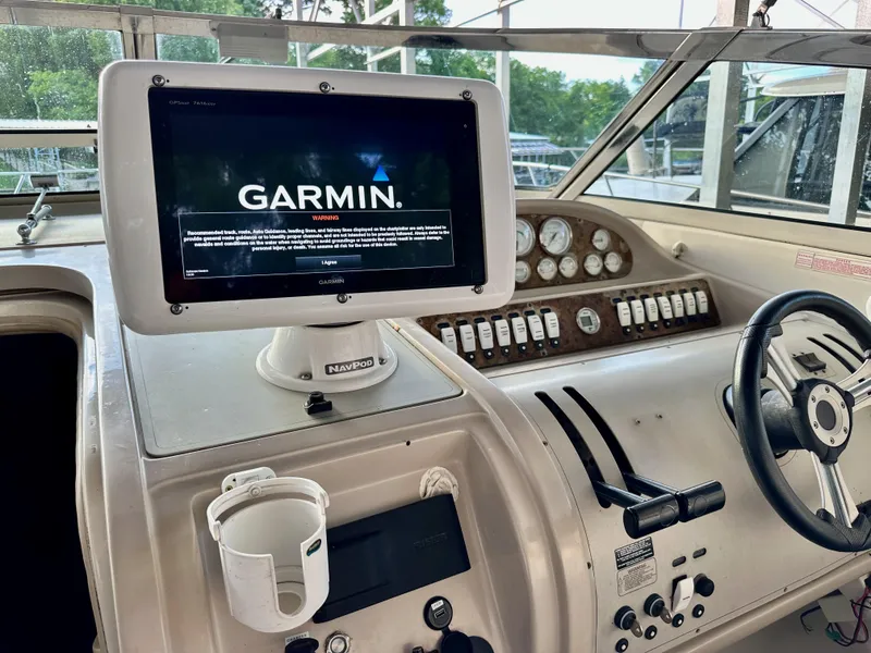 Slide: The Image of Cockpit of 1997 Regal Commodore 402 with Garmin navigation system and steering wheel. - 18