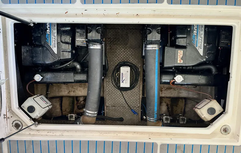 Slide: The Image of Engine compartment of a 1997 Regal Commodore 402 boat, featuring dual engines and mechanical components. - 19