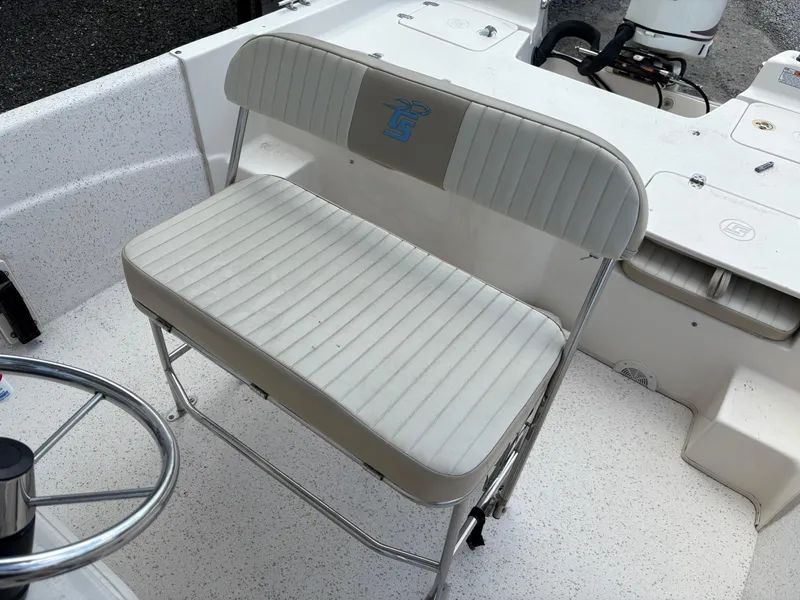 Slide: The Image of 2019 Carolina Skiff 198 DLV boat interior with white seating and steering wheel. - 10