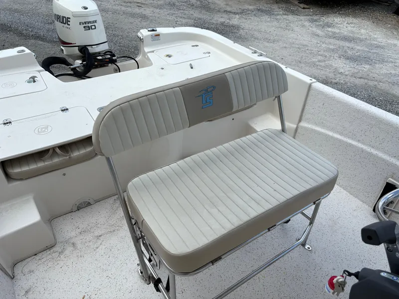 Slide: The Image of 2019 Carolina Skiff 198 DLV boat interior with Evinrude 90 engine and cushioned seating. - 11