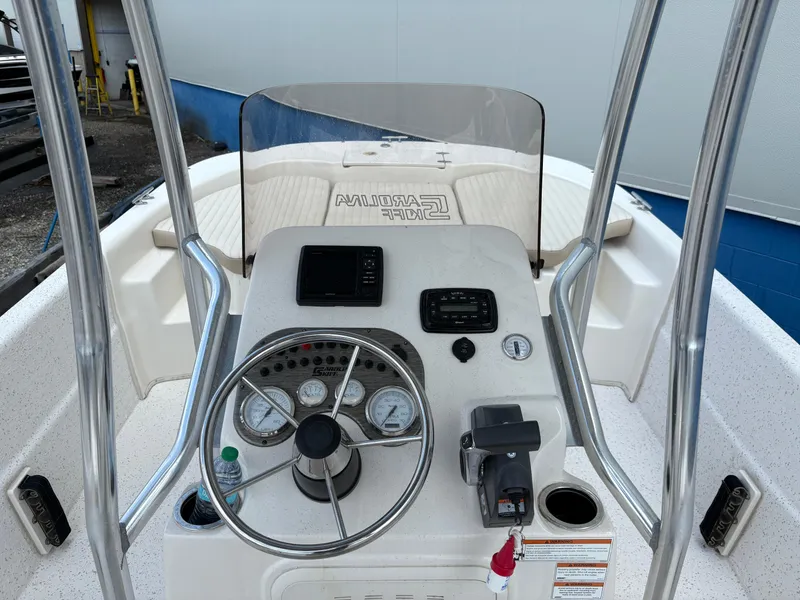 Slide: The Image of 2019 Carolina Skiff 198 DLV boat console with steering wheel and gauges. - 12