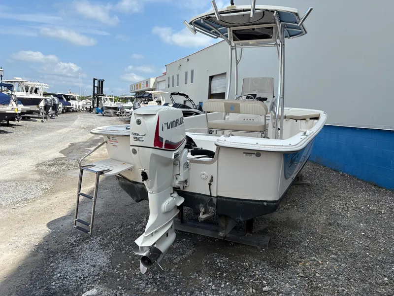 Slide: The Image of 2019 Carolina Skiff 198 DLV boat with Evinrude engine, parked outdoors. - 3