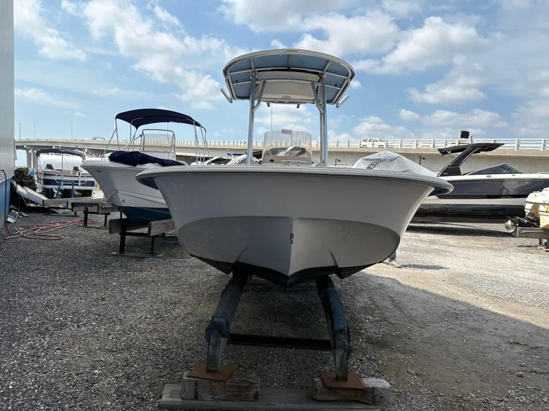 Slide: The Image of 2019 Carolina Skiff 198 DLV boat on trailer, parked outdoors under a cloudy sky. - 4