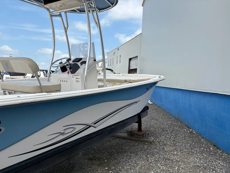 Slide: The Image of 2019 Carolina Skiff 198 DLV boat on display, featuring sleek design and blue accents. - 5
