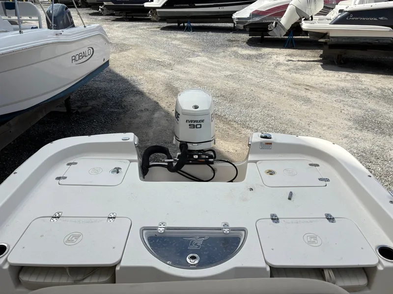 Slide: The Image of 2019 Carolina Skiff 198 DLV boat with Evinrude 90 engine in a boatyard. - 6