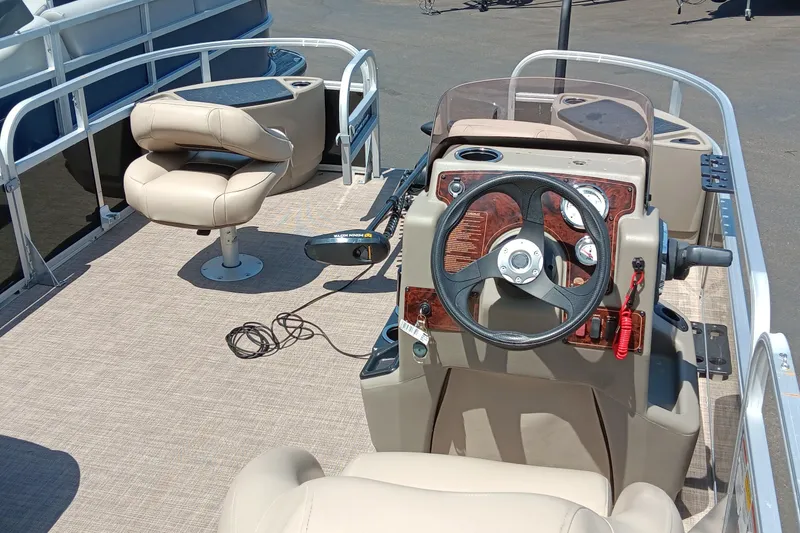 Slide: The Image of 2022 Sun Tracker Bass Buggy 18 DLX pontoon boat interior with steering console and seating. - 9