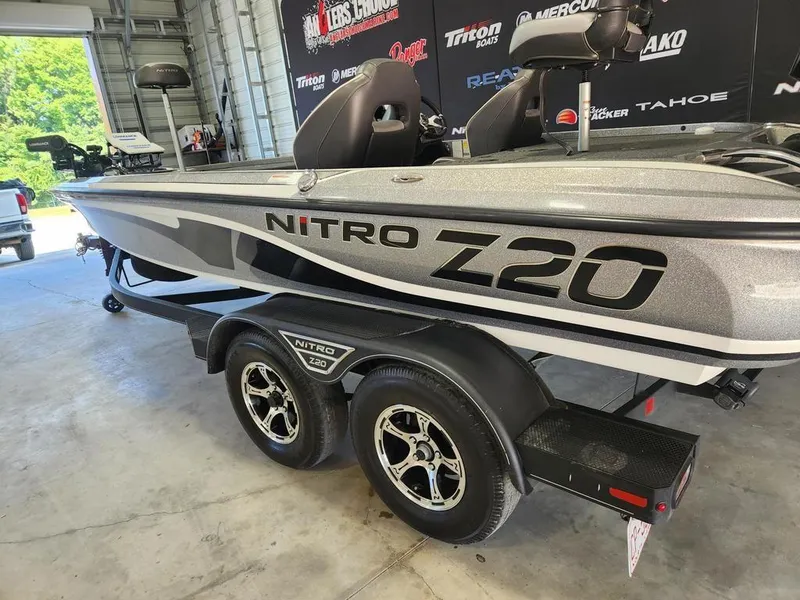 Slide: The Image of 2022 Nitro Z20 boat on trailer in garage, showcasing sleek design and branding. - 2
