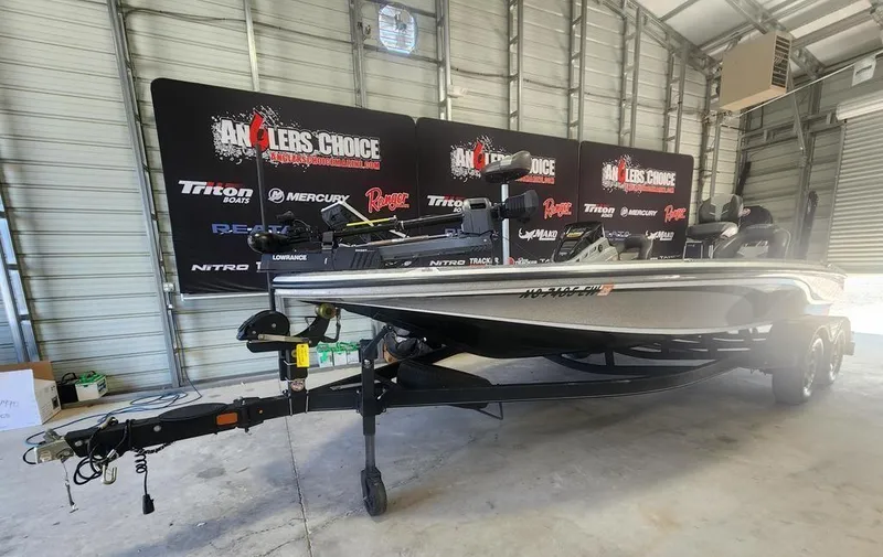 Slide: The Image of 2022 Nitro Z20 boat in a garage with Anglers Choice banners. - 4