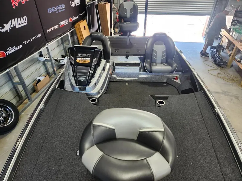 Slide: The Image of 2022 Nitro Z20 boat interior with seating and storage in a garage setting. - 5