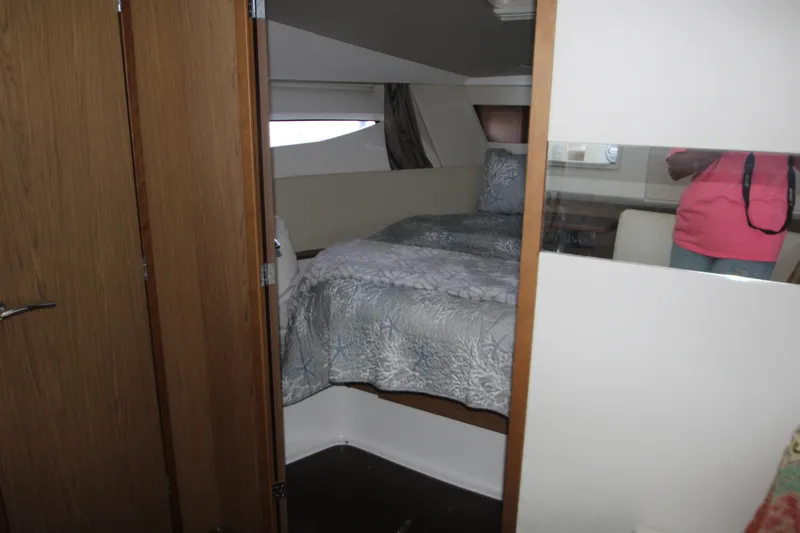 Slide: The Image of Cozy cabin bed in 2012 Jeanneau Leader 10 yacht with patterned bedding. - 12