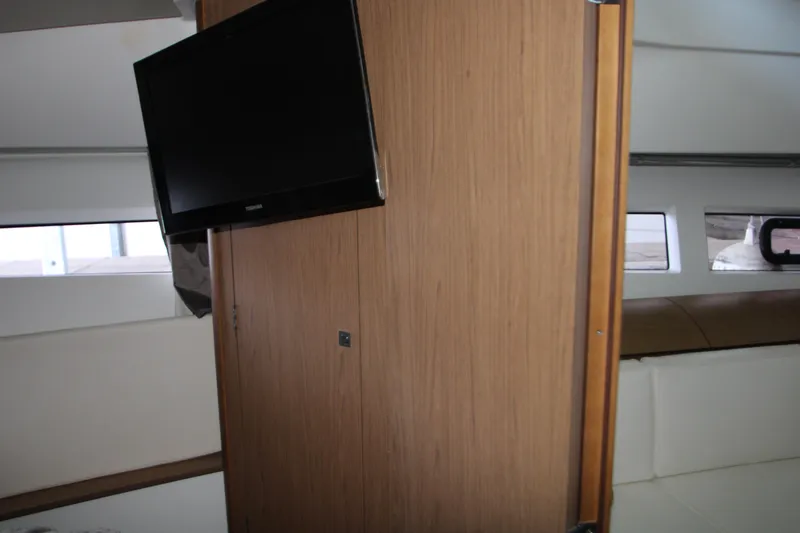 Slide: The Image of Interior cabin of 2012 Jeanneau Leader 10 yacht with bed and wooden door. - 13