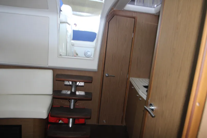 Slide: The Image of Interior of 2012 Jeanneau Leader 10 yacht with mounted TV and wooden paneling. - 14