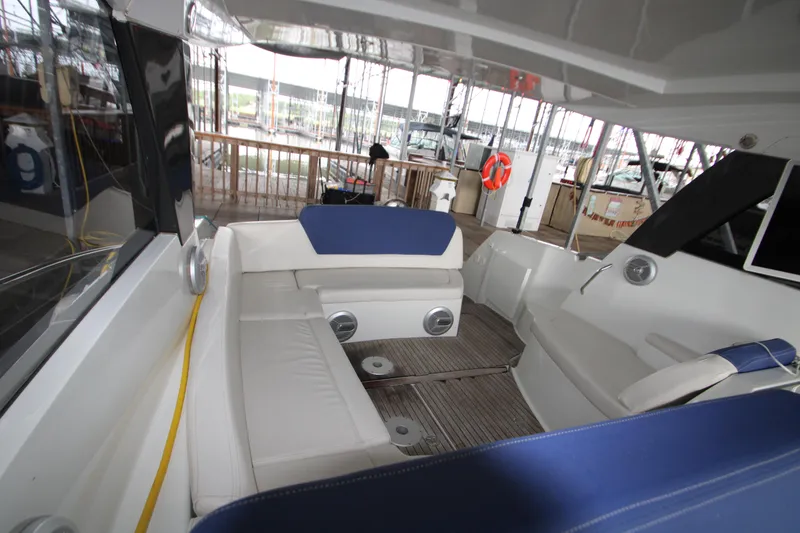 Slide: The Image of Interior view of 2012 Jeanneau Leader 10 yacht with white and blue seating. - 17