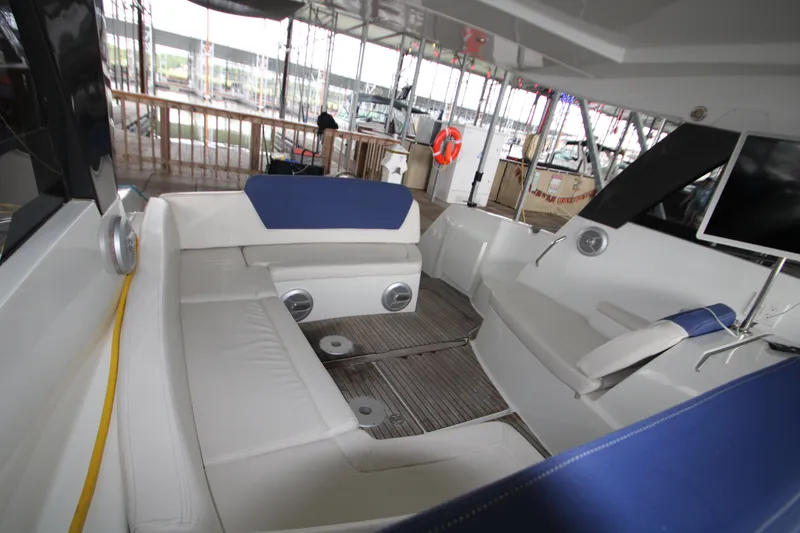 Slide: The Image of 2012 Jeanneau Leader 10 yacht interior with white and blue seating. - 18
