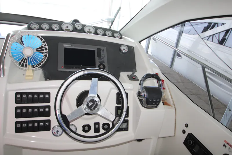 Slide: The Image of Cockpit of 2012 Jeanneau Leader 10 with steering wheel, controls, and fan. - 19
