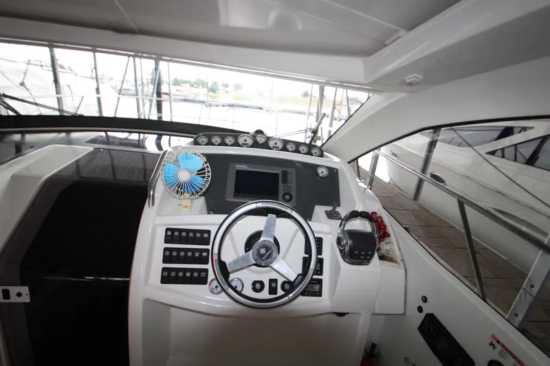 Slide: The Image of Cockpit of 2012 Jeanneau Leader 10 yacht with steering wheel and control panel. - 24
