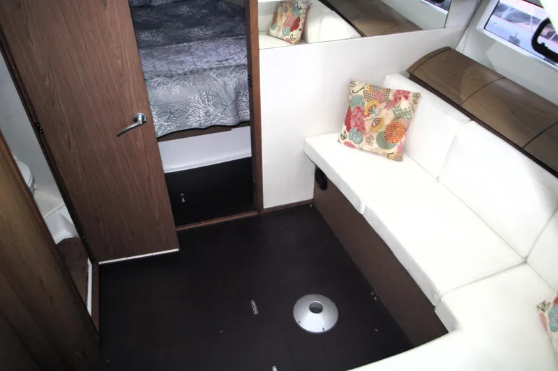 Slide: The Image of 2012 Jeanneau Leader 10 yacht docked in a covered marina. - 3