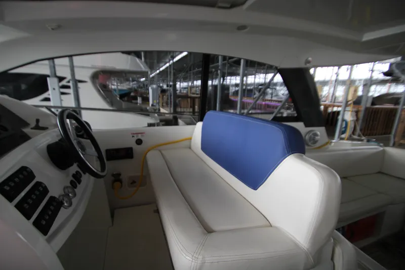 Slide: The Image of Interior of 2012 Jeanneau Leader 10 yacht with white and blue seating. - 34