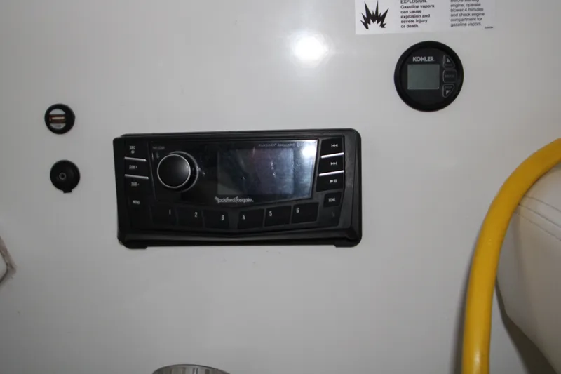 Slide: The Image of Control panel of a 2012 Jeanneau Leader 10 boat with audio system and digital display. - 38