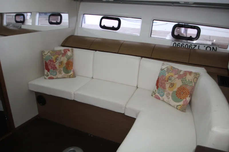 Slide: The Image of 2012 Jeanneau Leader 10 yacht docked in a covered marina. - 4