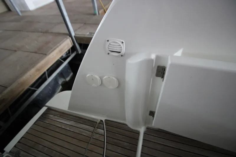 Slide: The Image of 2012 Jeanneau Leader 10 boat deck with white fittings and wooden flooring. - 44