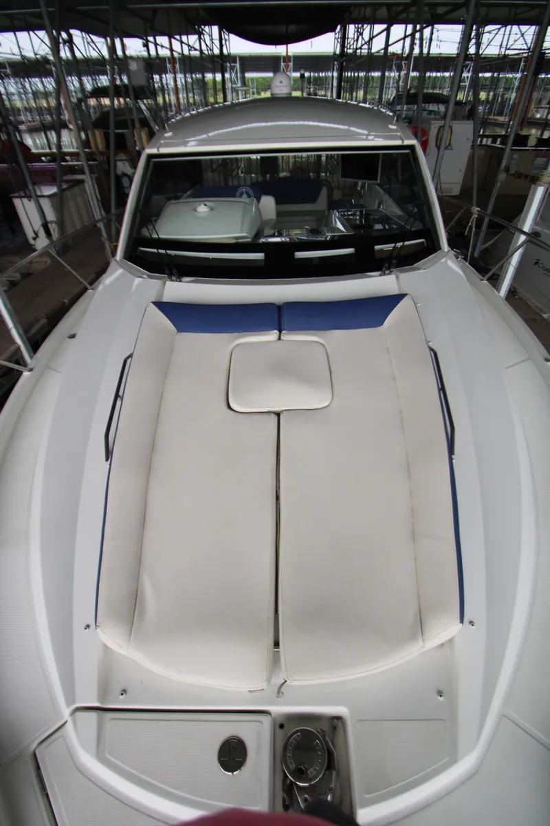 Slide: The Image of 2012 Jeanneau Leader 10 boat with cushioned deck, docked in a marina. - 47