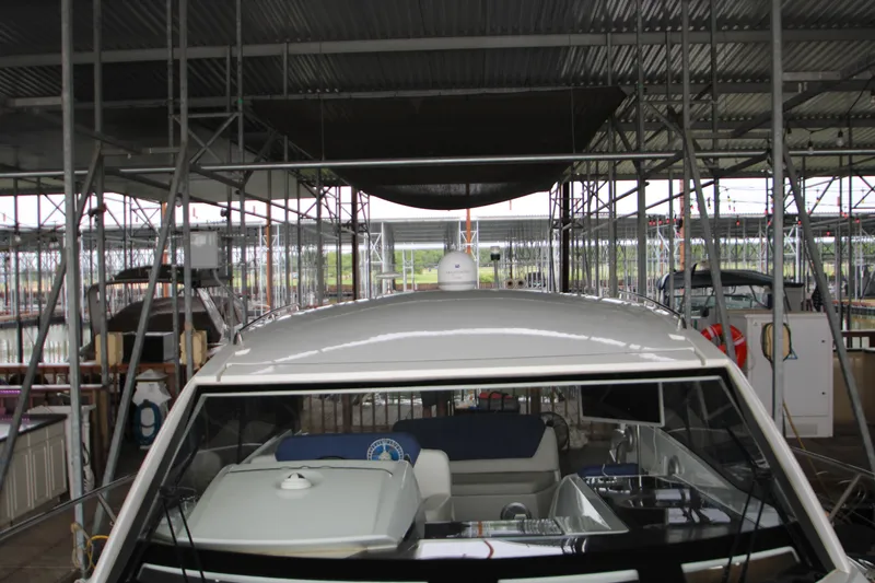 Slide: The Image of 2012 Jeanneau Leader 10 yacht docked in a covered marina. - 49