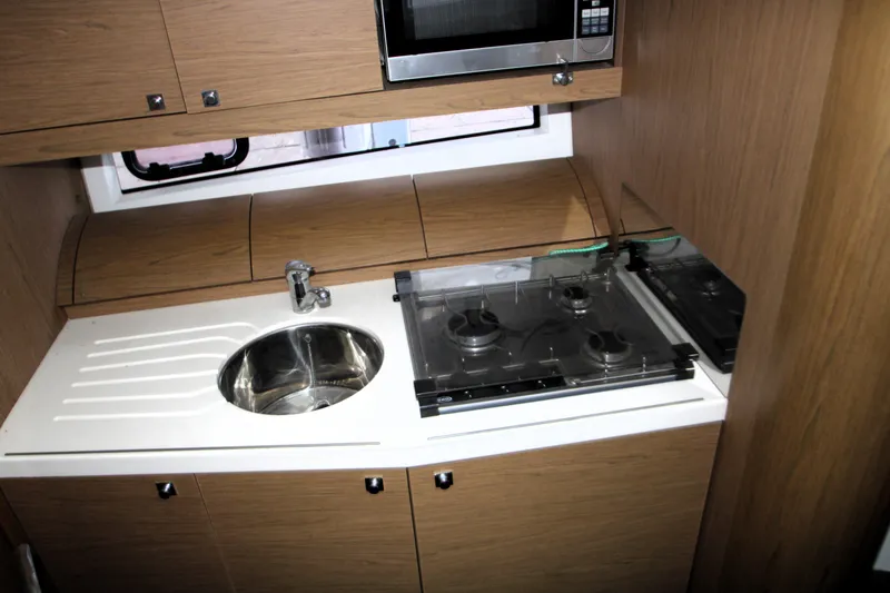 Slide: The Image of Interior of 2012 Jeanneau Leader 10 yacht kitchen with wood cabinets and sink. - 8