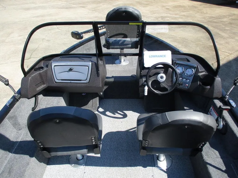 Slide: The Image of 2024 Tracker Pro Guide V-16 WT boat interior with steering wheel and seating. - 5