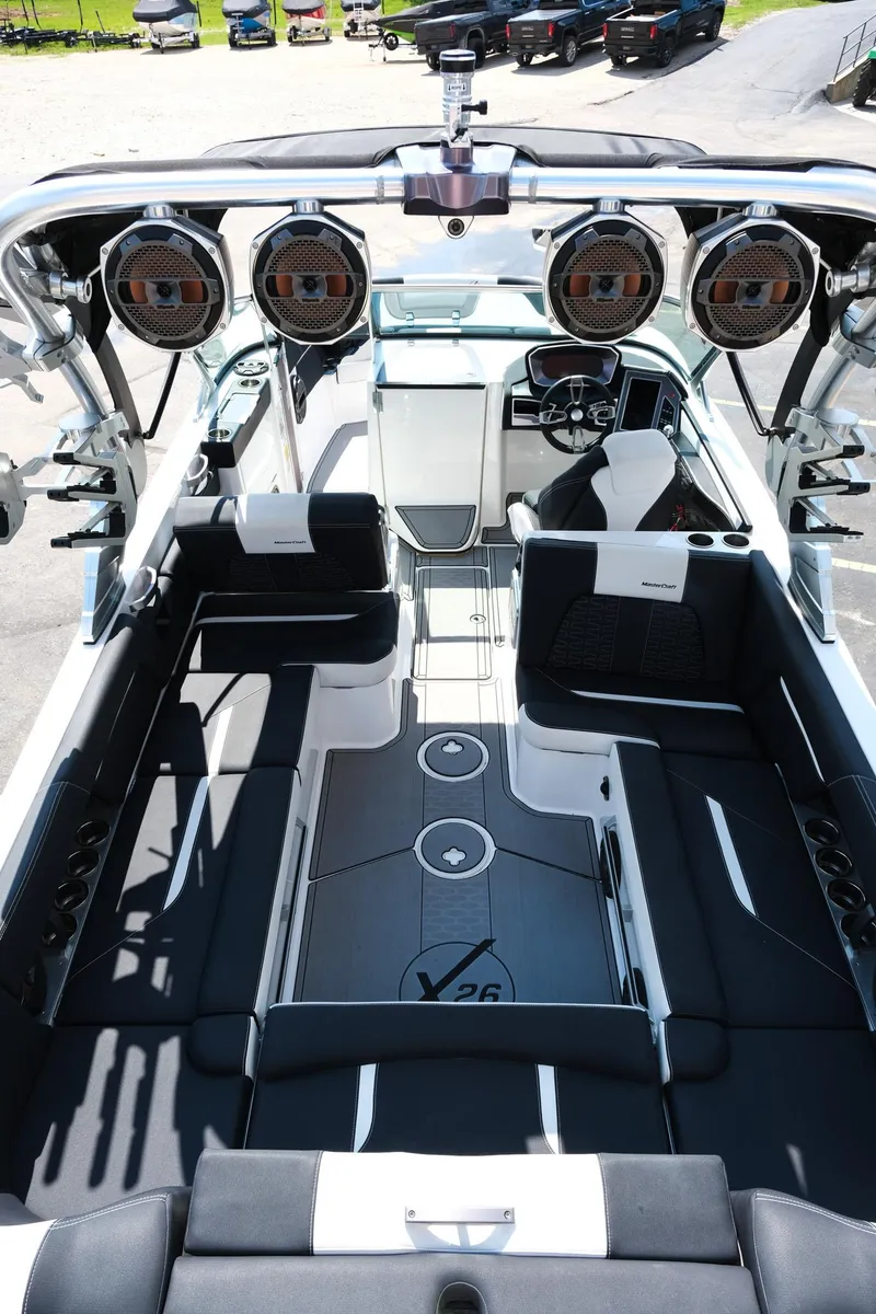 Slide: The Image of 2021 MasterCraft X26 boat interior with sleek seating and advanced audio system. - 11