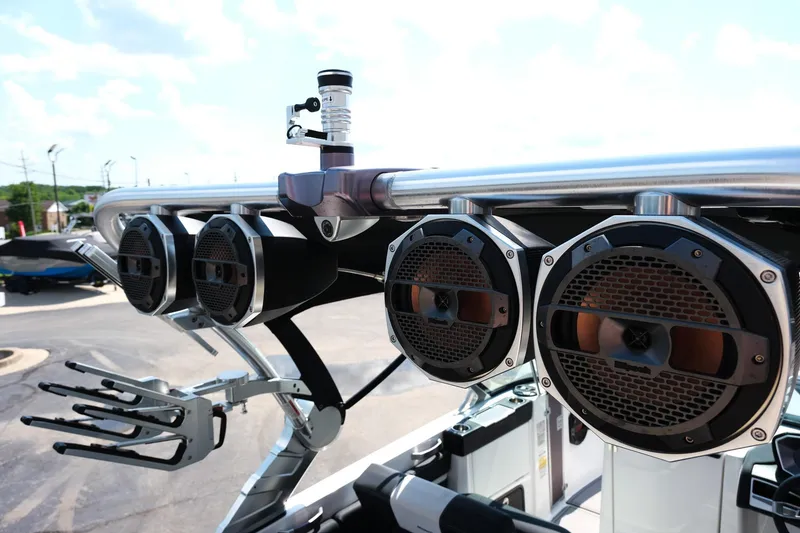Slide: The Image of 2021 MasterCraft X26 boat speakers and wakeboard rack on a sunny day. - 14