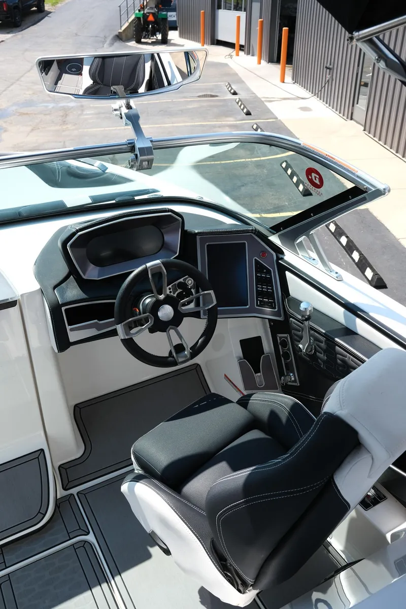 Slide: The Image of 2021 MasterCraft X26 boat cockpit with modern steering and controls. - 15