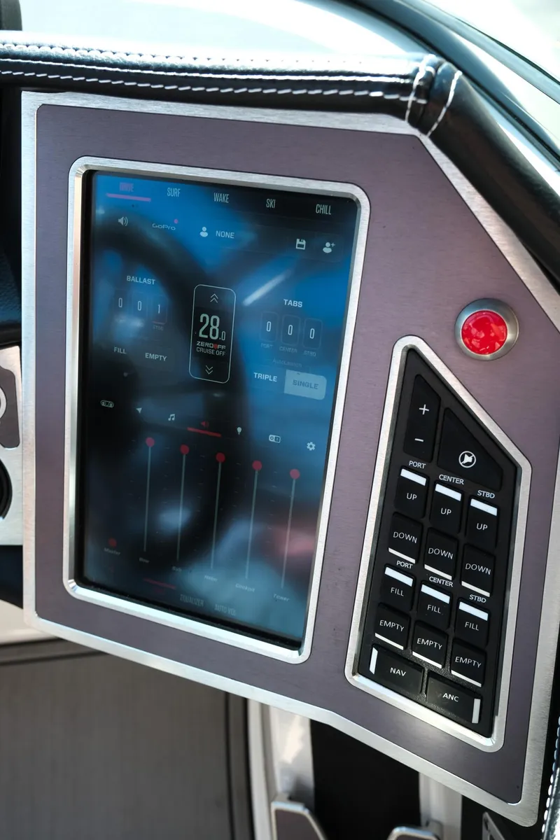 Slide: The Image of 2021 MasterCraft X26 boat control panel with touchscreen and buttons. - 18
