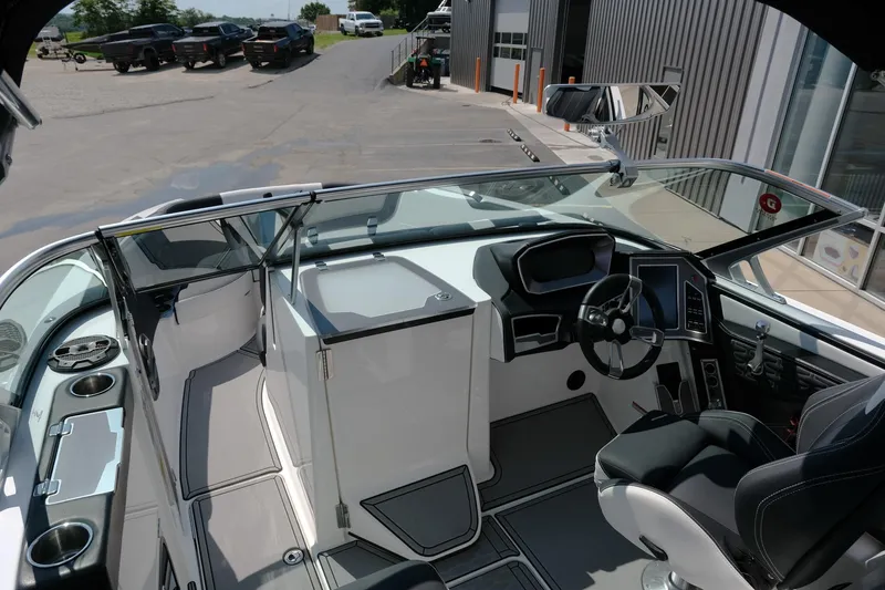 Slide: The Image of 2021 MasterCraft X26 boat interior with modern dashboard and steering wheel. - 25