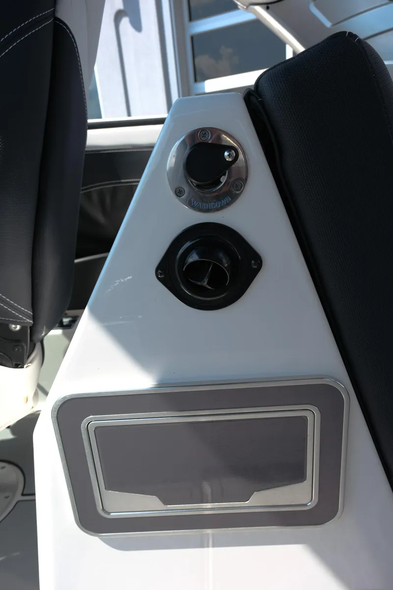 Slide: The Image of Interior detail of a 2021 MasterCraft X26 boat, featuring a control panel and seating. - 27