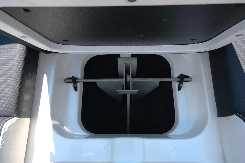 Slide: The Image of Open storage compartment in a 2021 MasterCraft X26 boat. - 32
