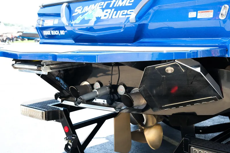 Slide: The Image of 2021 MasterCraft X26 boat rear view with propeller and trim tabs. - 7