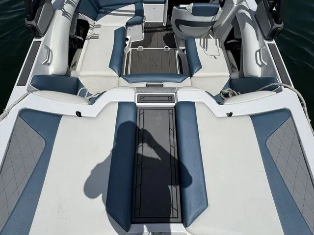 Slide: The Image of 2019 Tigé R21 boat interior with blue and white seating. - 16