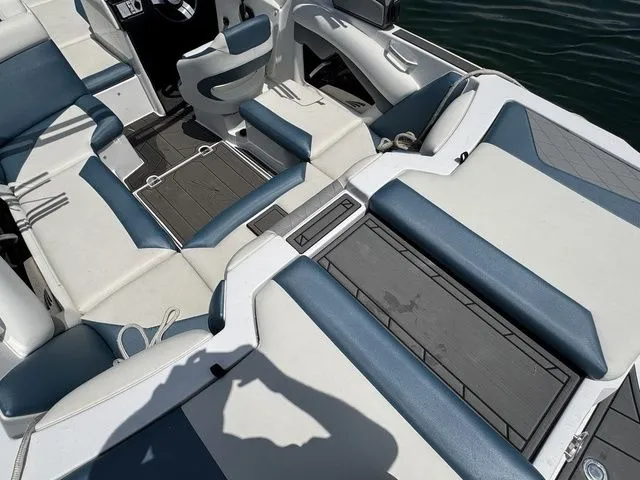 Slide: The Image of 2019 Tigé R21 boat interior with blue and white seating, showcasing spacious layout. - 17