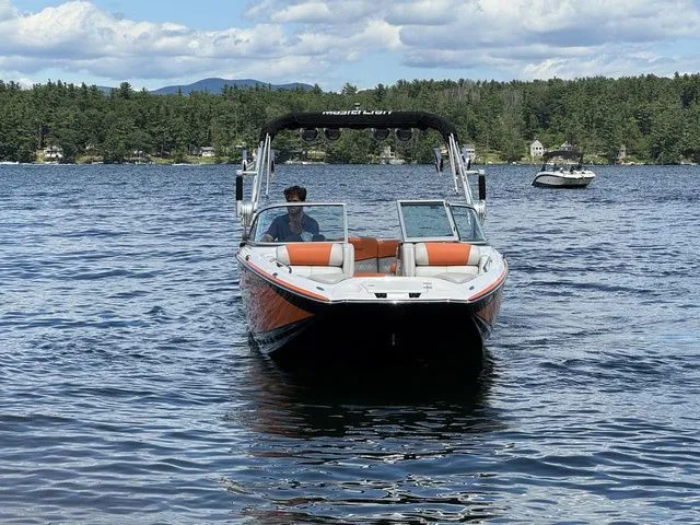 Slide: The Image of 2012 MasterCraft X-35 boat on a lake with scenic forest background. - 14