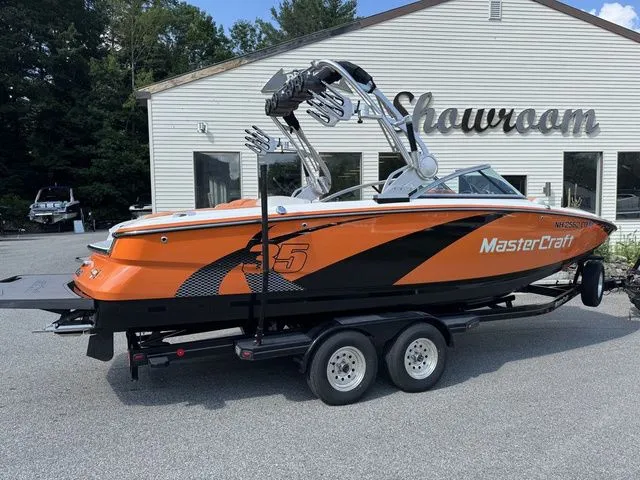 Slide: The Image of 2012 MasterCraft X-35 boat in orange and black, parked outside a showroom. - 15